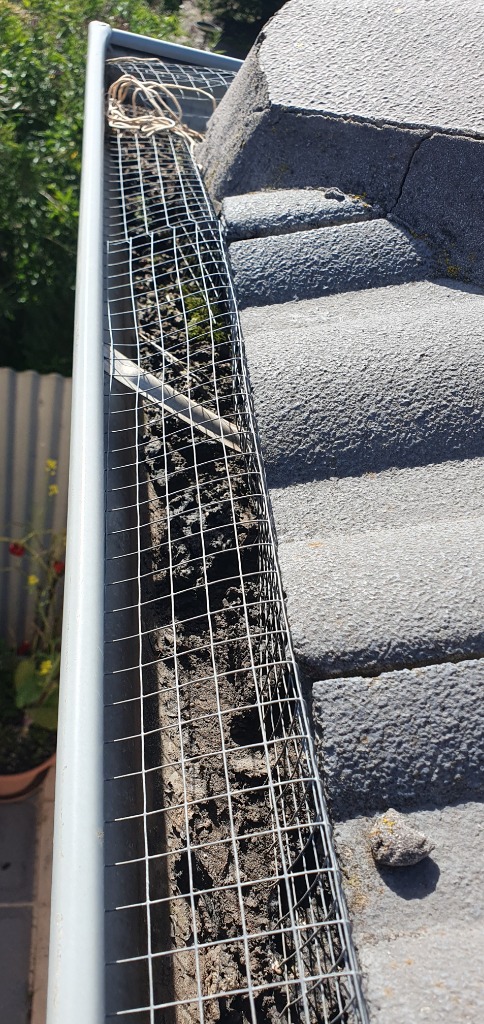Blocked gutter with debris found during house inspection